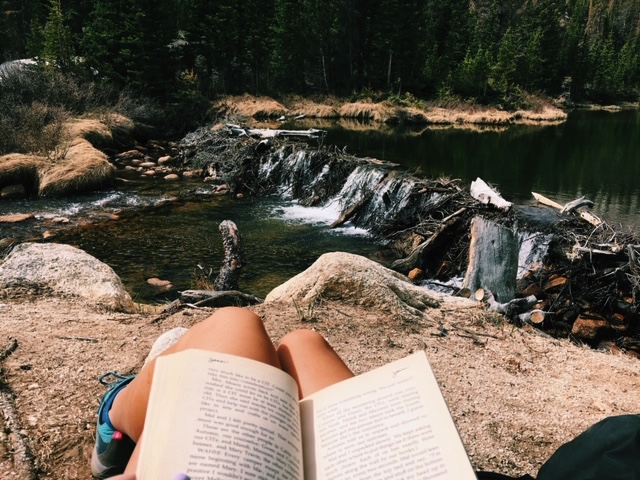Alice reading by river